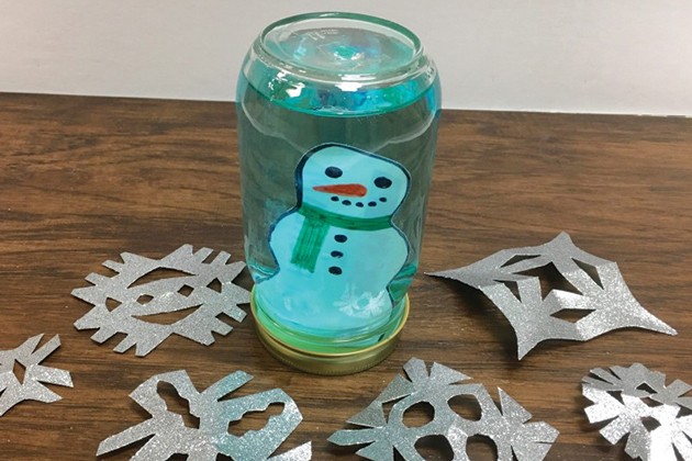 A completed snow globe with a snowman inside.