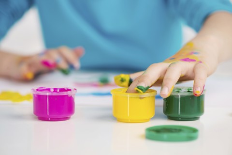 Homemade finger paints in small containers.